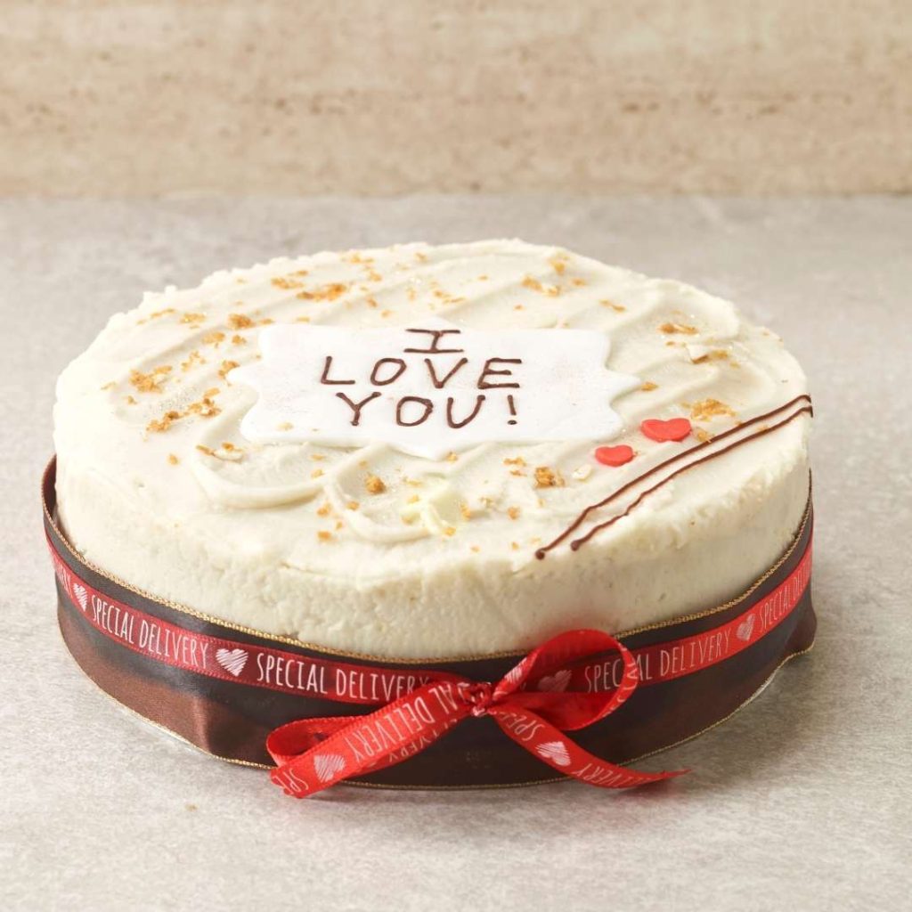 Image of vegan carrot cake with zesty lemon frosting, topped with grated carrots and warm spices. Perfect for weddings, birthdays, and special occasions. Nut-free and available in gluten-free option