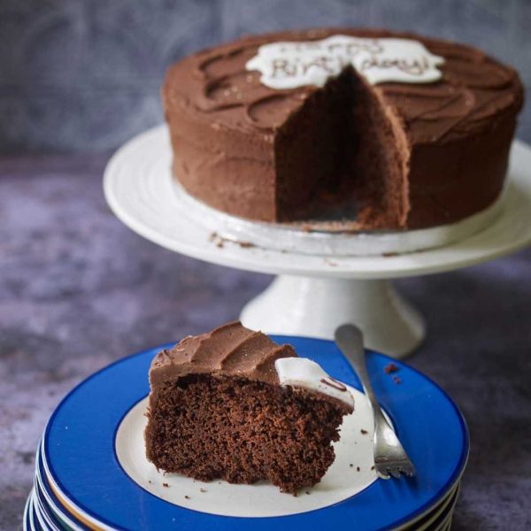 Vegan gluten free chocolate cake with a slice on a plate