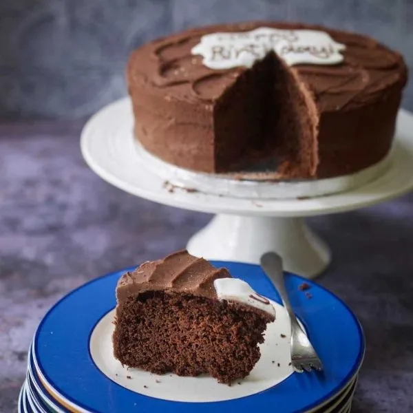 Vegan gluten free chocolate cake with a slice on a plate