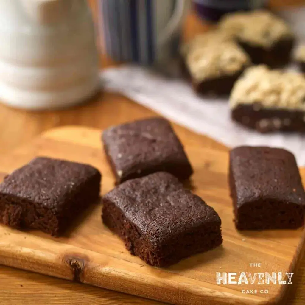 Chunky gluten free brownies displayed on a wooden chopping board