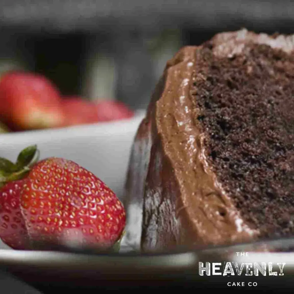 A slice of chocolate chip vegan birthday cake served with a strawberry